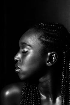 Elegant monochrome portrait of a woman in side profile with braided hair.