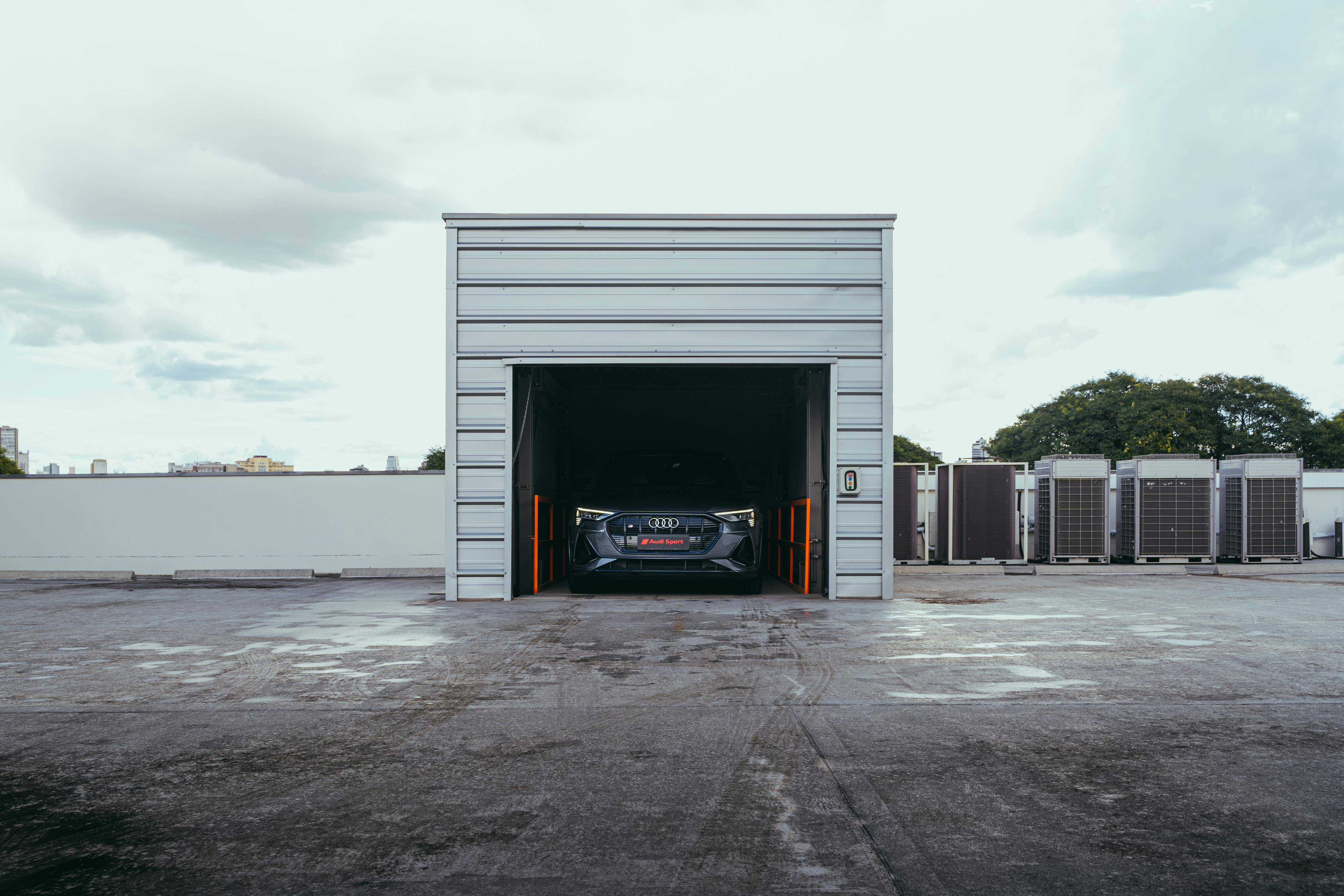 Electric car parked in a modern garage in Curitiba, Brazil, featuring urban infrastructure.