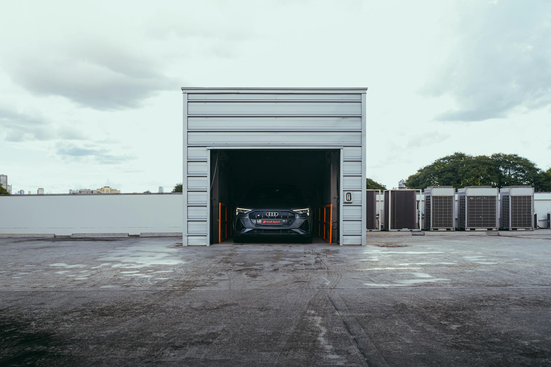 Electric car parked in a modern garage in Curitiba, Brazil, featuring urban infrastructure.