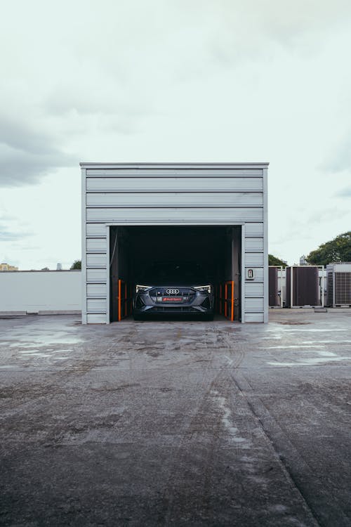 A Black Car Parked in a Garage · Free Stock Photo