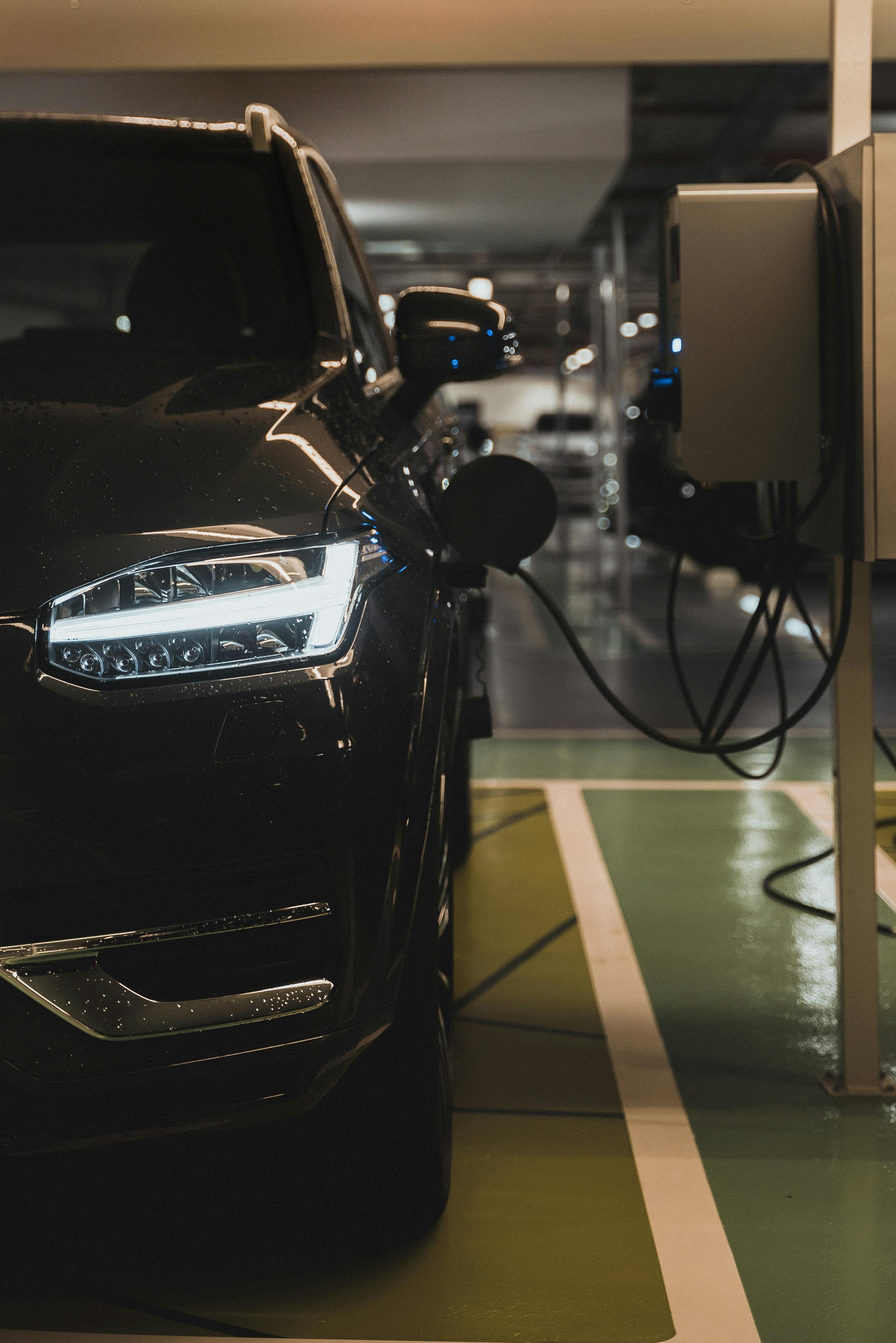 a black electric vehicle charging on a charging station