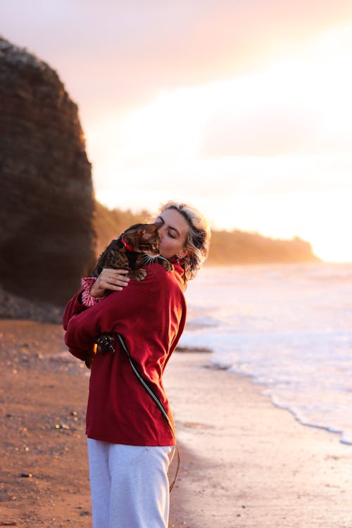 Woman Hugging Her Cat on the Beach 