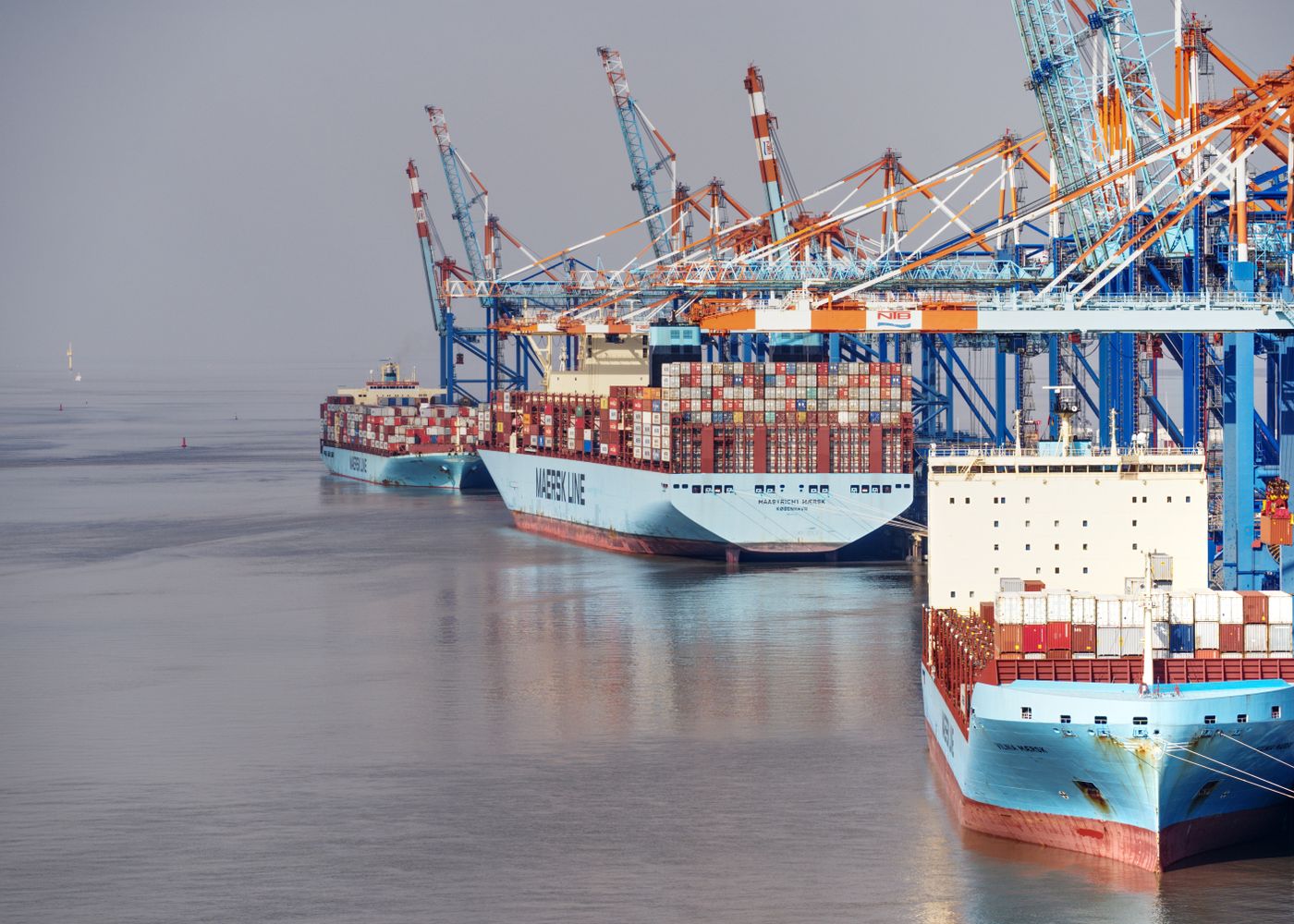 Container ships docked at a busy export port with cranes