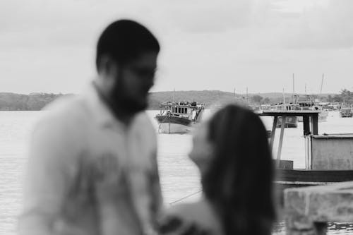 Couple Standing near Boats on Sea