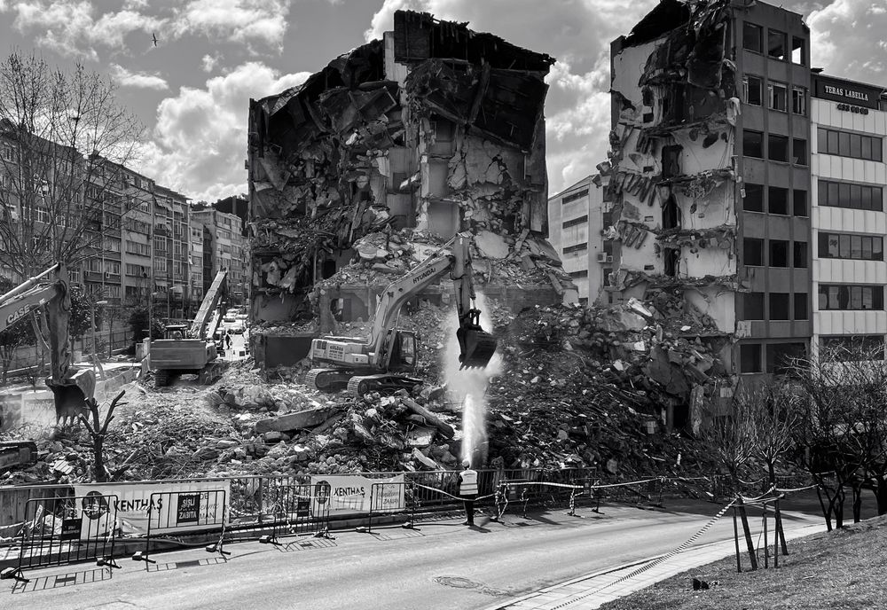 Bulldozers tearing down a building during demolition