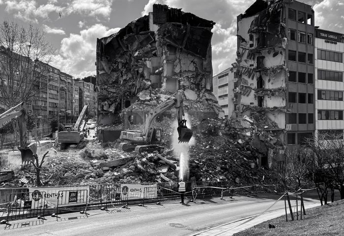 Excavators demolishing a building