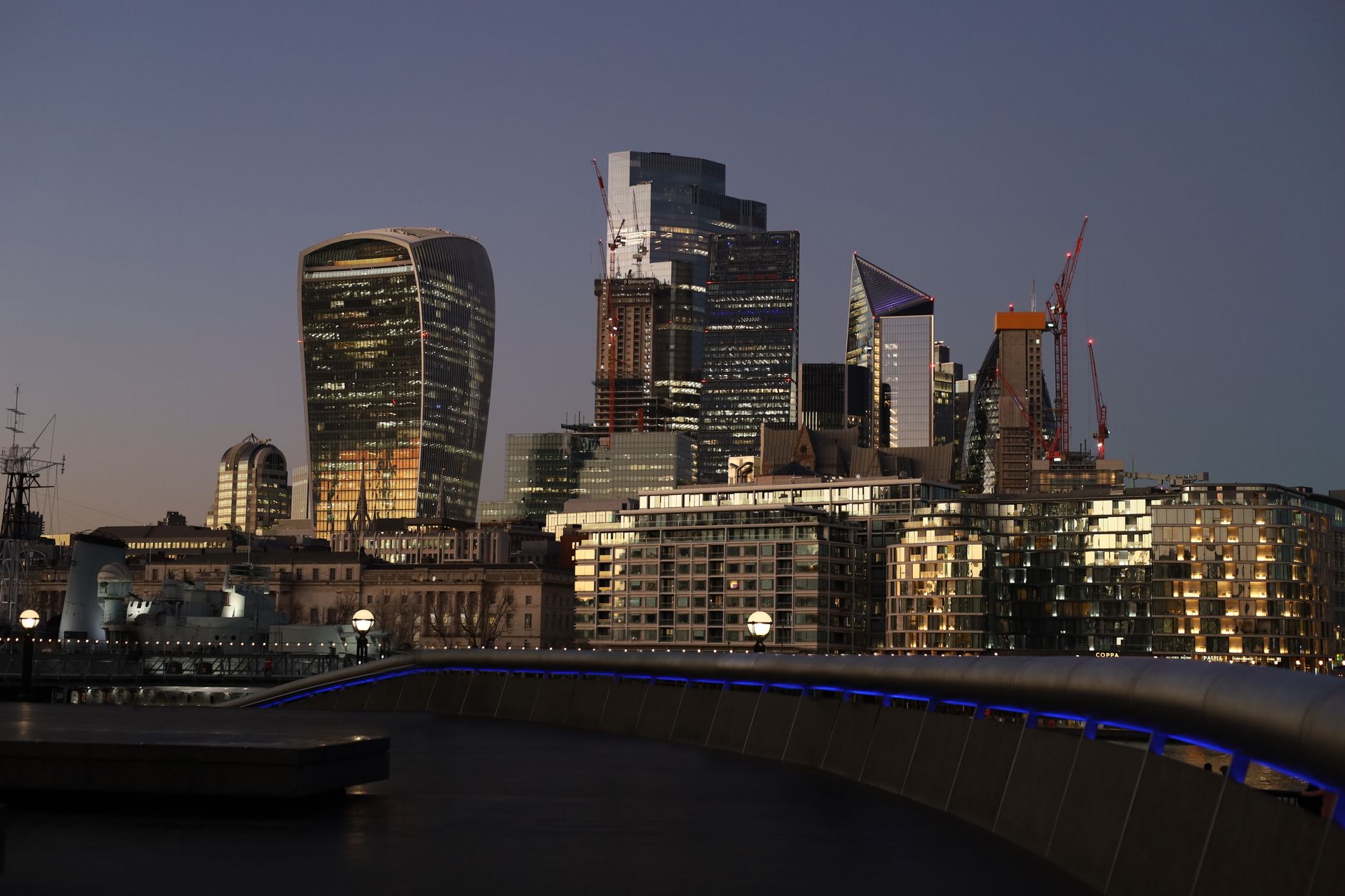 A minimalist luxury office overlooking a global financial hub at twilight, symbolizing strategic asset oversight and stability.