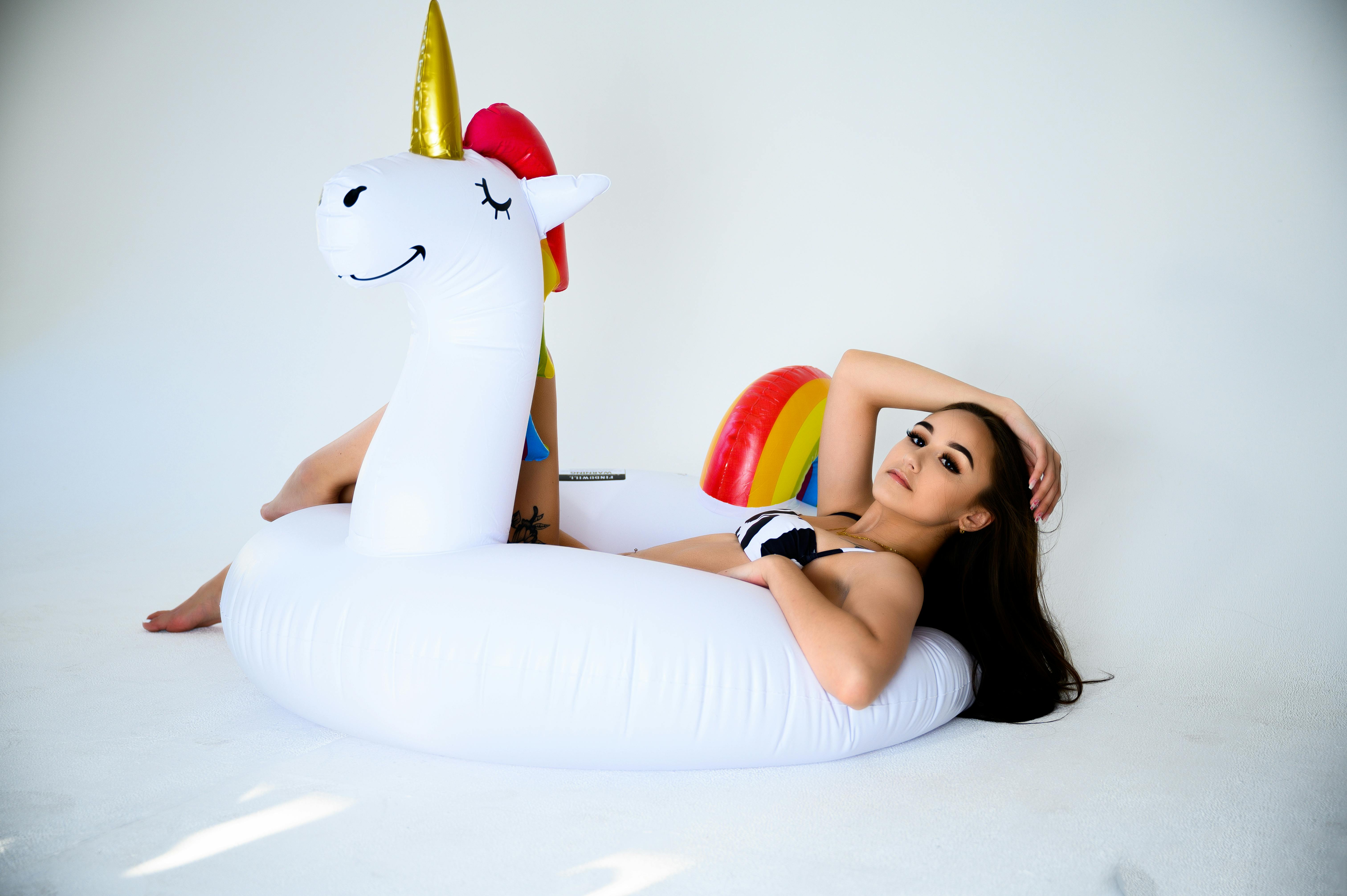 woman lying on unicorn floaty