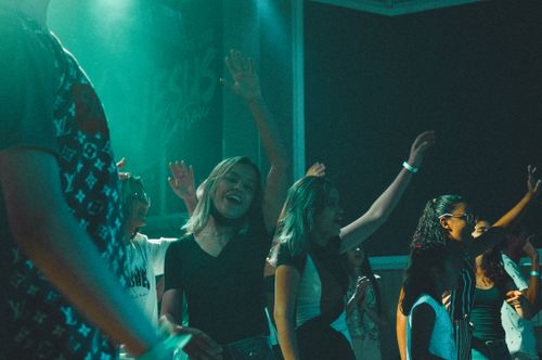 Free A lively party atmosphere with people dancing and celebrating indoors at night. Stock Photo