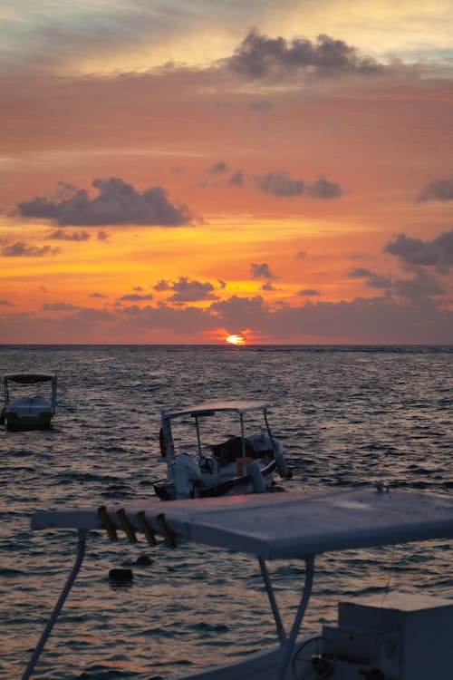 Free White and Black Boat on Sea during Sunset Stock Photo