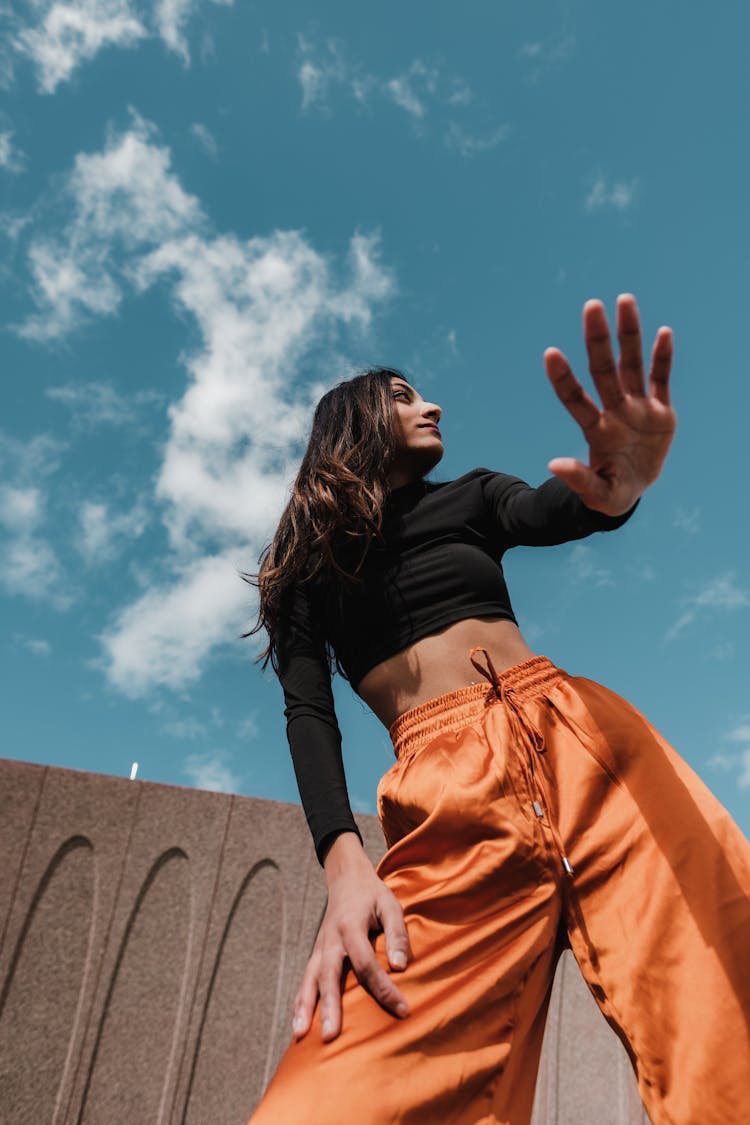 Low Angle View Of Woman Holding Out Hand