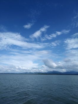 Peaceful ocean view with white clouds and mountains in Darién, Panama.