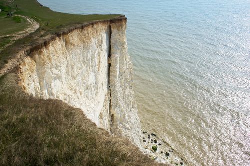 Free Majestic white cliffs in Eastbourne, UK overlooking the sea, under a clear sky. Stock Photo