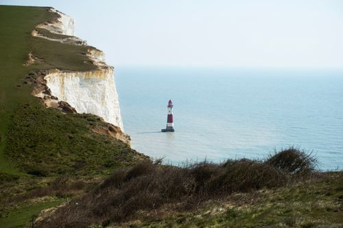Free Stunning view of the iconic Beachy Head Lighthouse beside towering white cliffs near Eastbourne, UK. Stock Photo