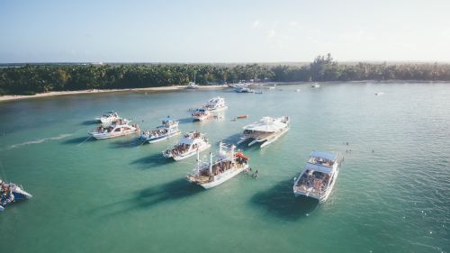 Free Aerial shot of several boats and yachts anchored near a tropical beach. Stock Photo