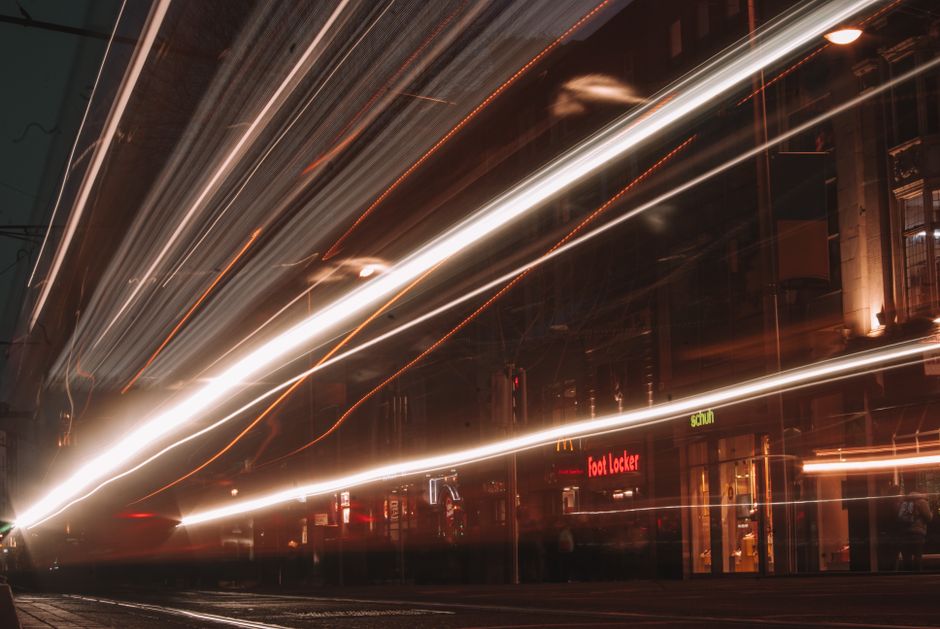 Long exposure capture of light streaks on a bustling city street at night, showcasing urban energy. Long exposure capture of light streaks on a bustling city street at night, showcasing urban energy.