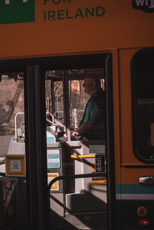 Free A bus driver focuses on the road while navigating city streets in a public transportation bus. Stock Photo