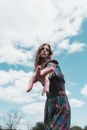 Woman in Green and Blue Dress Under Blue Sky