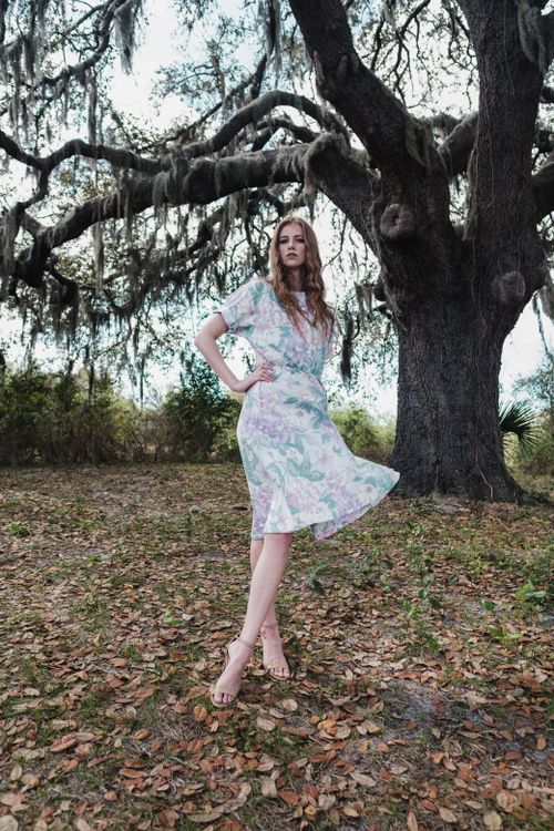 Stylish Woman in Floral Dress standing in front of a Tree · Free Stock ...