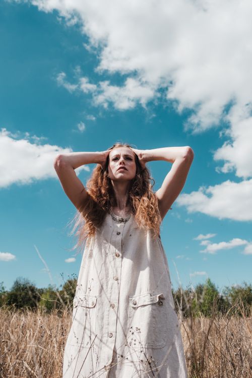 Beautiful Woman in White Dress on a Brown Grass Field · Free Stock Photo