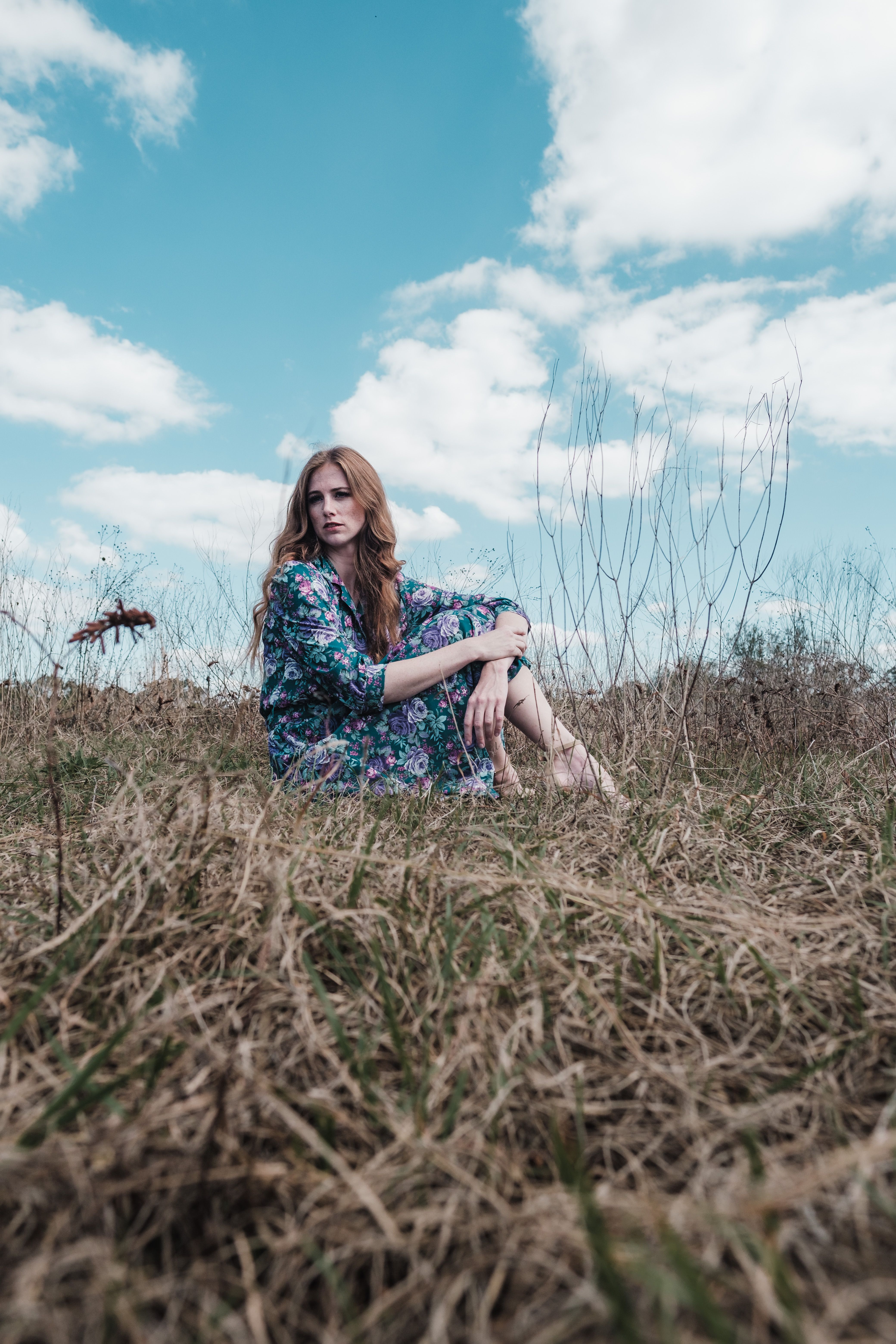 A Woman in Blue Floral Dress Sitting on the Grass · Free Stock Photo