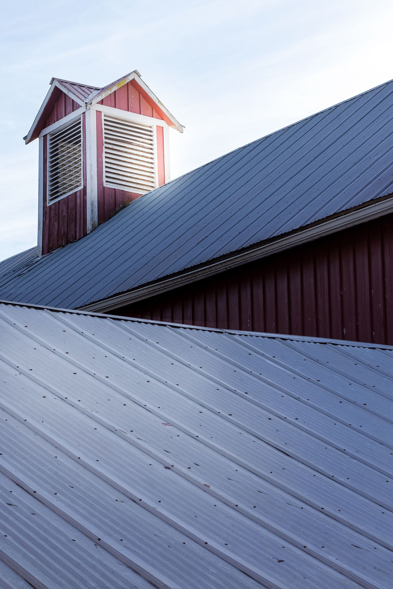Blue-gray metal roof with a ventilated cupola