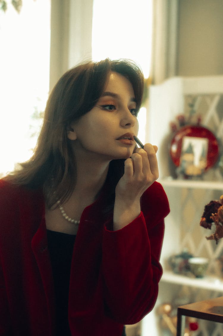 Elegant Woman Putting On Lipstick