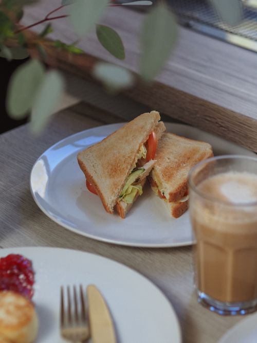 Free Close-up of a sandwich with coffee and jam on a wooden table. Stock Photo