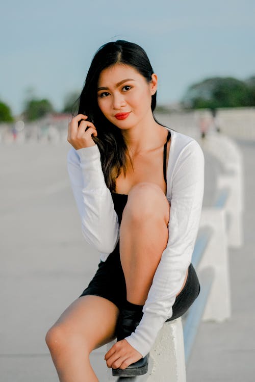 Free Woman in a White Long Sleeve Top Sitting Stock Photo