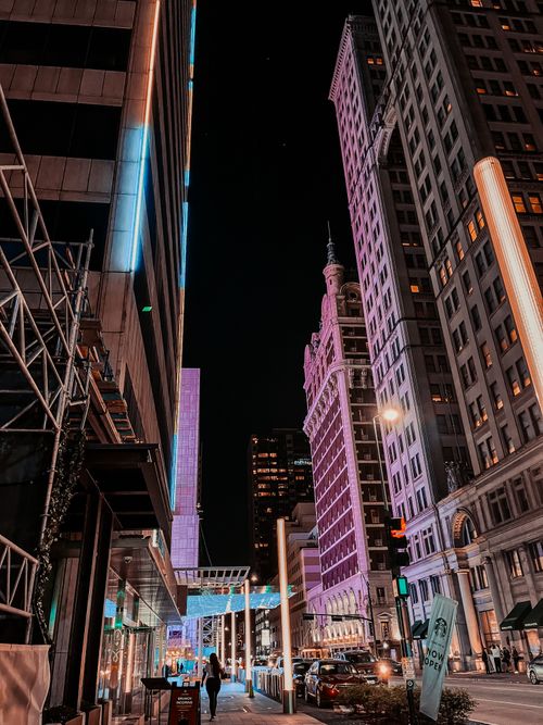 Free Explore a vibrant urban night scene featuring illuminated skyscrapers and bustling city life. Stock Photo