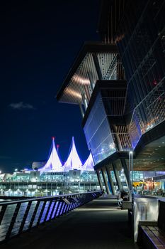 Illuminated Vancouver Convention Centre at night, showcasing its modern architecture and city lights.