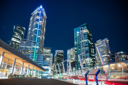 Stunning view of Vancouver's skyline with towering high-rises against a starry night sky.