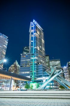 Illuminated night view of Vancouver's skyline featuring modern architecture and iconic landmarks.