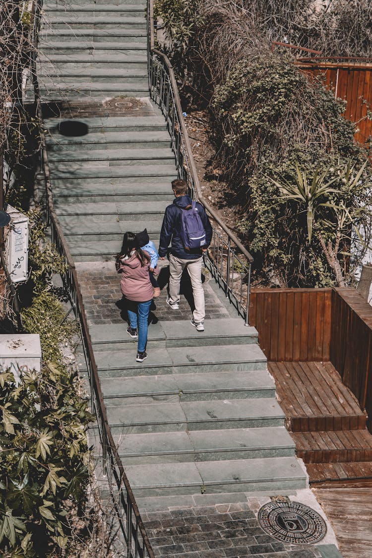 Family Walking Up On Stairs