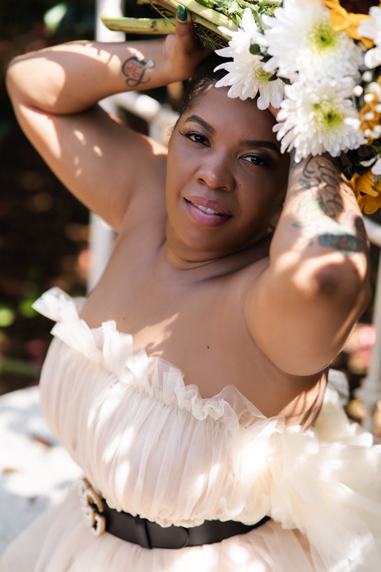 Bridesmaid Holding A Bouquet Over Her Head 