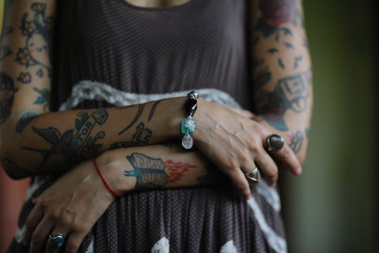 Close-up Of Woman With Tattoos On Arms