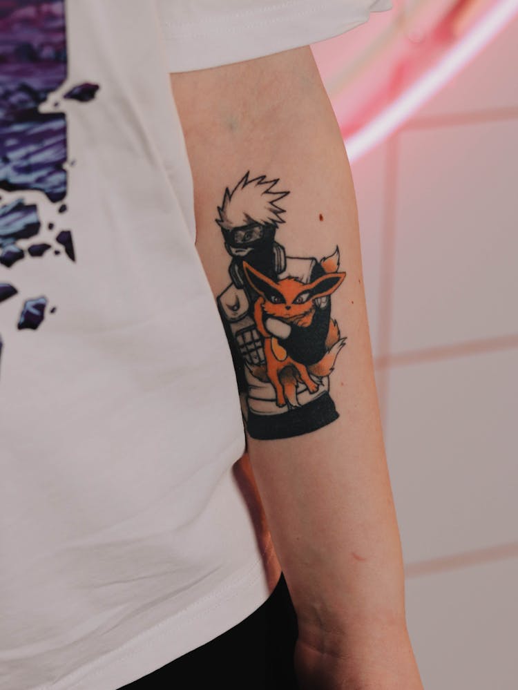 Tattoo Of A Manga Character On A Mans Arm