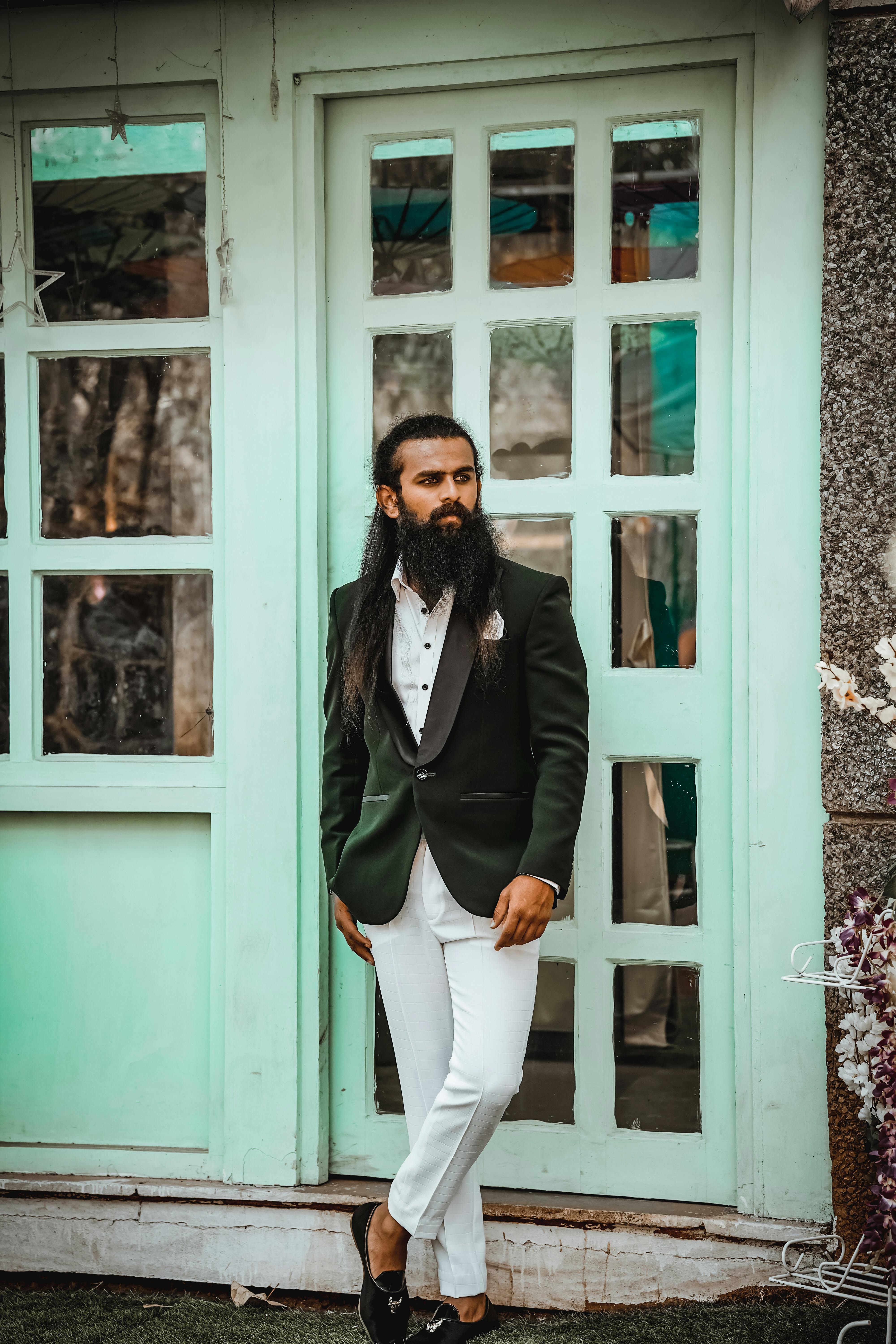 Dressing in a white undershirt, a black blazer, green pants and a green  tie, one hand touching his lips, a young black guy with mohawk hair is  standin Stock Photo - Alamy
