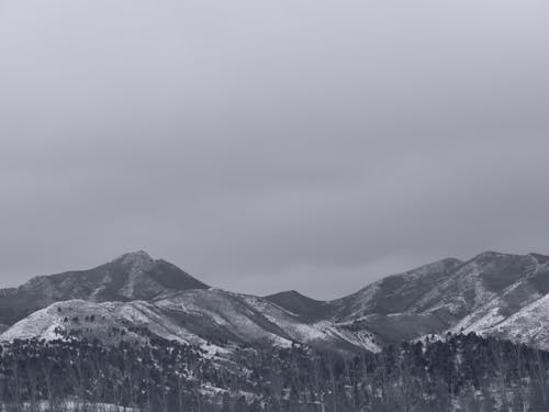 Snow Covered Mountain Under Gloomy Sky