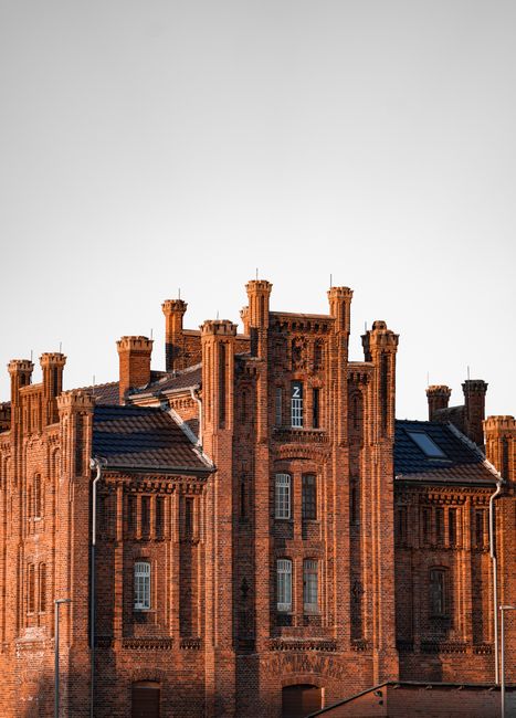 Captivating view of a historic brick building showcasing intricate facade details under a clear sky.