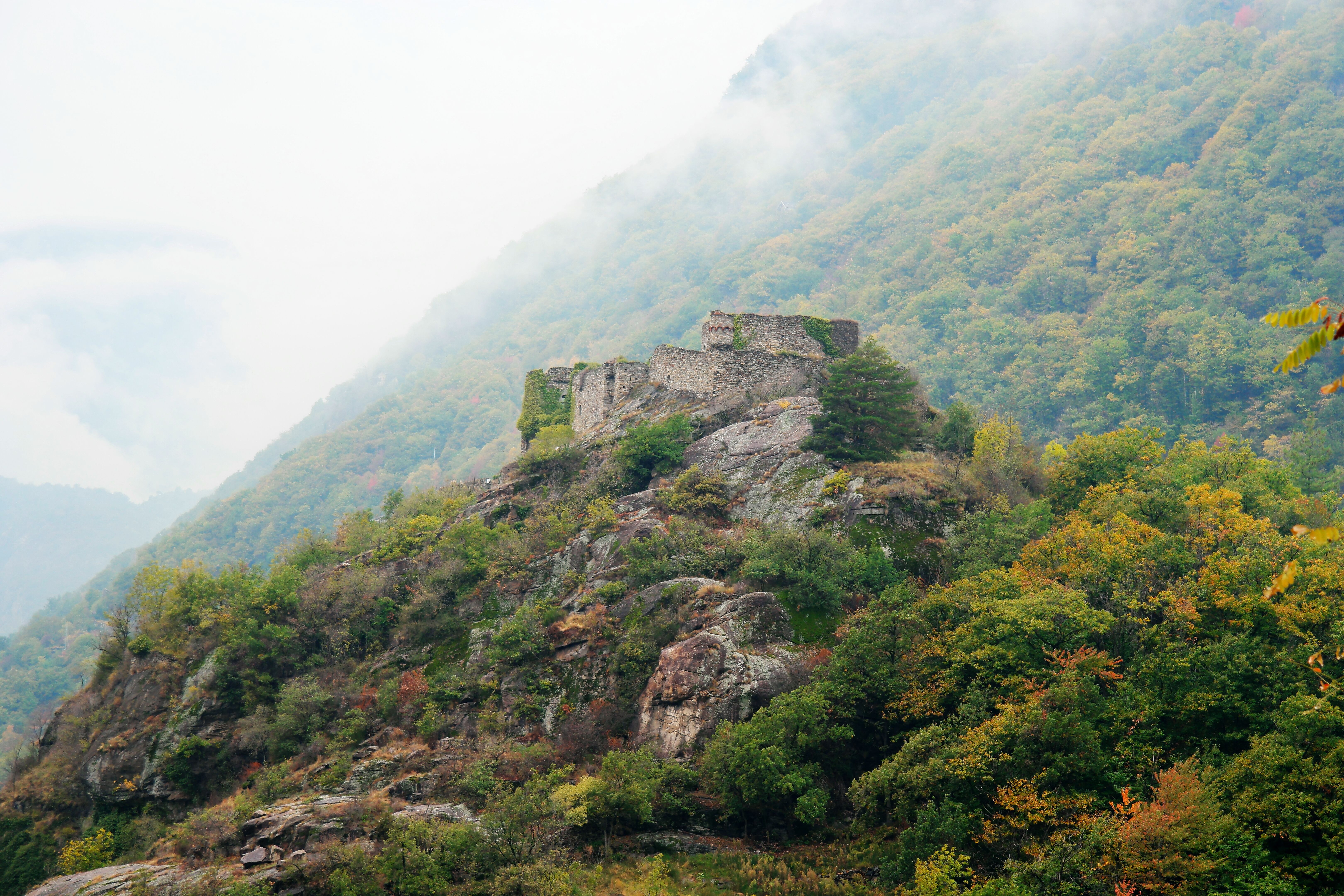 Stone ruins atop a misty, overcast hill