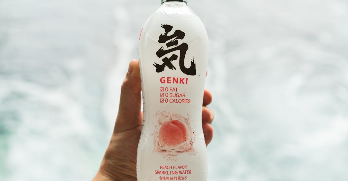 Person Holding White Plastic Bottle