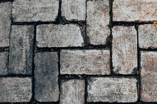 Detailed image of gray stone paving blocks with earthy tones showcasing rustic texture.
