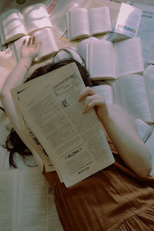 Free Woman in Bed Reading Newspaper Stock Photo