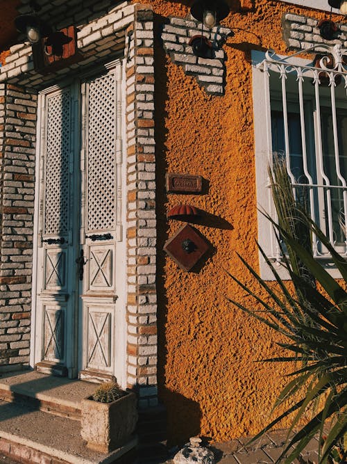 White Wooden Door on Brown Concrete House