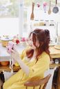 Woman in Yellow Shirt Holding Pink and White Cupcake