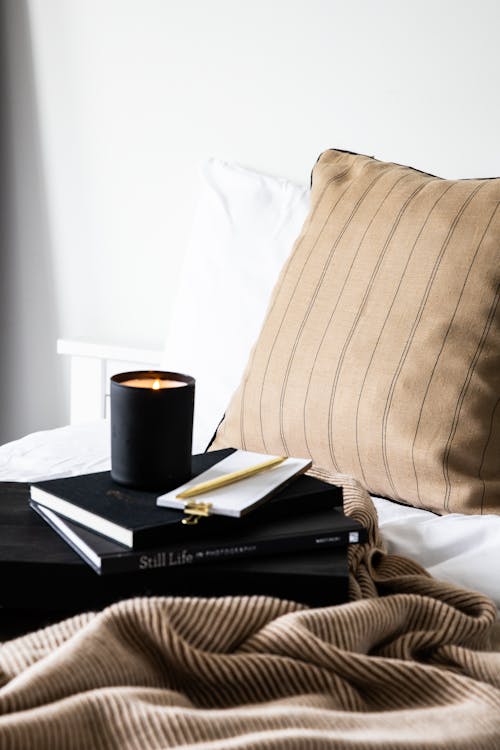 Free Candle and Books on Bed Stock Photo