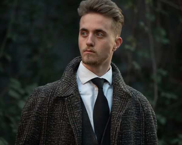 Man in tweed jacket with stripe tie