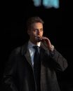 Man in Black and Gray Plaid Suit Jacket Smoking Cigarette