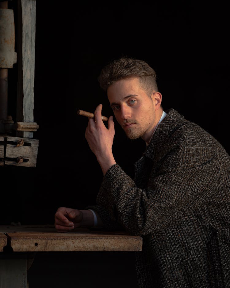 A Man In A Tweed Coat Holding A Tobacco